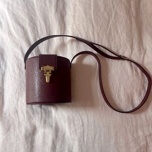 Super cute tiny hatbox purse by DÔEN in a lovely burgundy.